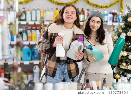 Women friends choose detergent and spray in decorated store 130273804