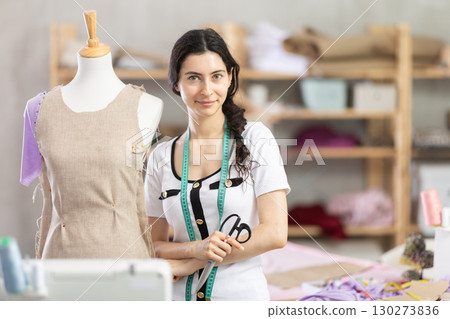 woman dressmaker stands in the workshop 130273836