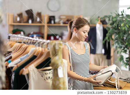 Woman choosing a handbag in a store 130273839