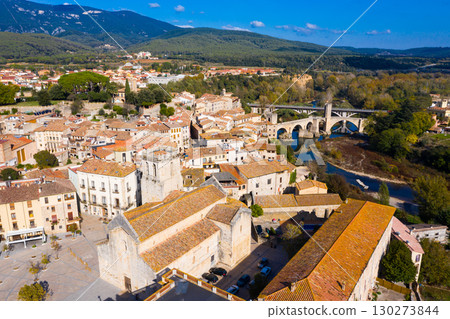 View from drone of Besalu with arched bridge over Fluvia river 130273844