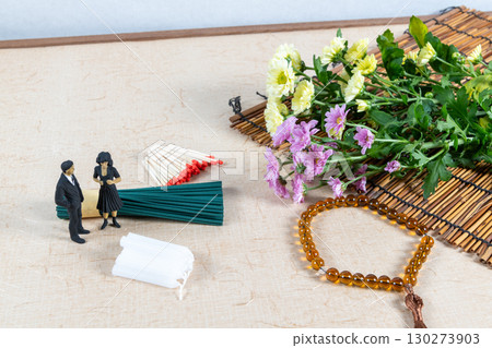 Grave visit accessories and a small doll in mourning clothes Grave visit accessories and a small doll in mourning clothes 130273903