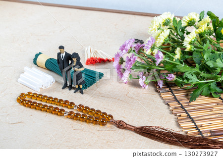 Grave visit accessories and a small doll in mourning clothes Grave visit accessories and a small doll in mourning clothes 130273927