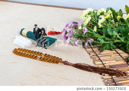 Grave visit accessories and a small doll in mourning clothes 130273928