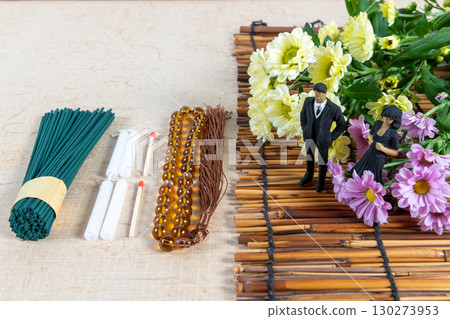 Grave visit accessories and a small doll in mourning clothes 130273953