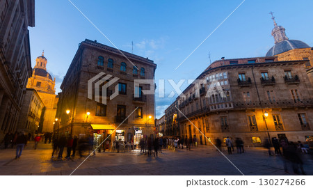 Busy Plaza de Anaya of Salamanca with illuminated buildings on spring evening 130274266