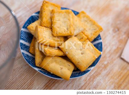 Thin crackers with sesame seeds on plate 130274415