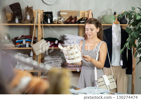 Woman choosing a handbag in a store 130274474