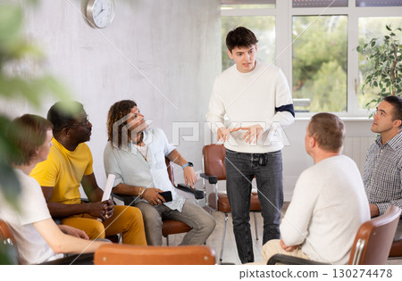 Young man teacher reading lecture for a group of guys 130274478