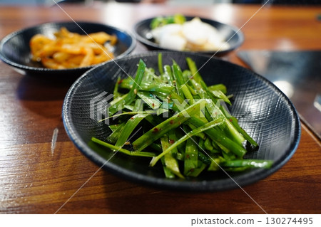 Korean Side Dishes with Fresh Garlic Chives and Assorted Banchan 130274495