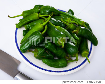 Closeup of many fresh green bell pepper on background. Healthy nutrition concept Closeup of many fresh green bell pepper on background. Healthy nutrition concept 130274503