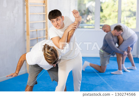 Two men training judo technique in studio Two men training judo technique in studio 130274566
