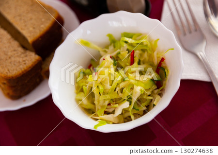 Appetizing salad of Russian cuisine, made from fresh cabbage with cucumber Appetizing salad of Russian cuisine, made from fresh cabbage with cucumber 130274638