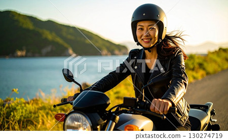 A woman touring the seaside on a motorcycle on her day off 130274719