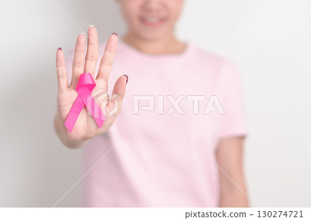 Pink October Breast Cancer Awareness month, woman with pink Ribbon for concepts of support people life and illness. National cancer survivors month, Women Health day and February World cancer day 130274721