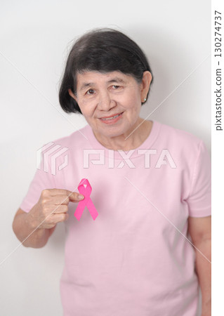 Elderly woman with pink Ribbon for Pink October Breast Cancer Awareness month, May Women Health, February World cancer day, support people life and illness. National cancer survivors month Elderly woman with pink Ribbon for Pink October Breast Cancer Awareness month, May Women Health, February World cancer day, support people life and illness. National cancer survivors month 130274737