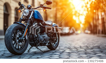 Blue Motorcycle on Cobblestone Street with Golden Sunset Lightin Blue Motorcycle on Cobblestone Street with Golden Sunset Lightin 130275486