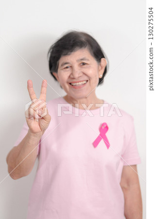 Elderly woman with pink Ribbon for Pink October Breast Cancer Awareness month, May Women Health, August World Breastfeeding week, Nursing Mothers, Pregnancy and Infant Loss Remembrance, Stillbirth 130275504