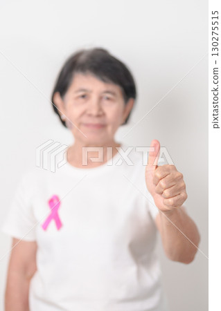 Elderly woman with pink Ribbon for Pink October Breast Cancer Awareness month, May Women Health, August World Breastfeeding week, Nursing Mothers, Pregnancy and Infant Loss Remembrance, Stillbirth 130275515