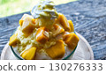 Shaved ice topped with lots of mango 130276333