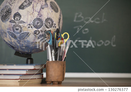 A classic 'Back to School' scene with books, a globe, and school supplies. 130276377