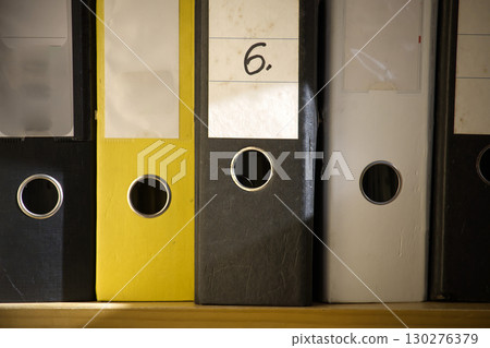 The image shows a close-up of several ring binder folders, neatly arranged and ready for use. 130276379