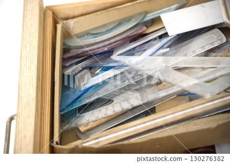 A drawer filled with various rulers and geometric tools for measurement. A drawer filled with various rulers and geometric tools for measurement. 130276382