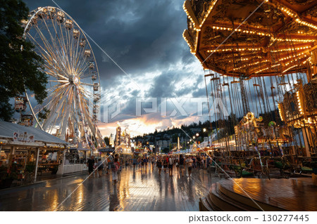 Twilight summer carnival with glowing ferris wheel lights Twilight summer carnival with glowing ferris wheel lights 130277445