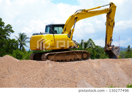 The excavator is digging a sand. 130277496