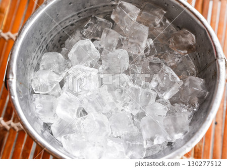 Ice cube in the stainless steel bucket 130277512