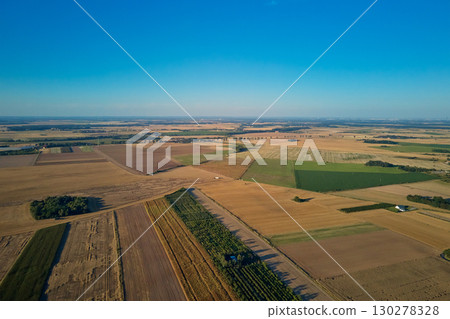 Aerial landscape of farmland with agricultural fields under clear sky 130278328