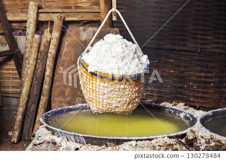 Traditional salt production with woven bamboo basket filled in rural workshop 130278484