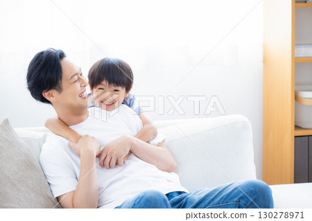 Family: Father and son relaxing on the sofa Family: Father and son relaxing on the sofa 130278971