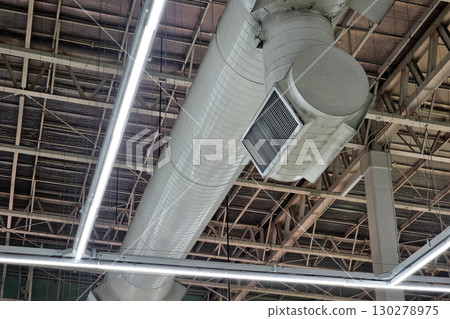 Industrial HVAC Ductwork and Lighting System in Building Ceiling. 130278975