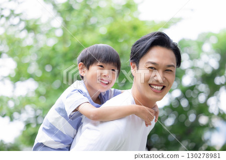 Family: Boy being carried on his father's back 130278981