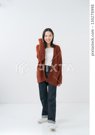 A woman in a knitted dress making a fist pump A woman in a knitted dress making a fist pump 130278998