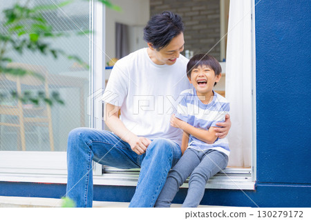 Family: Father and son relaxing in the garden Family: Father and son relaxing in the garden 130279172