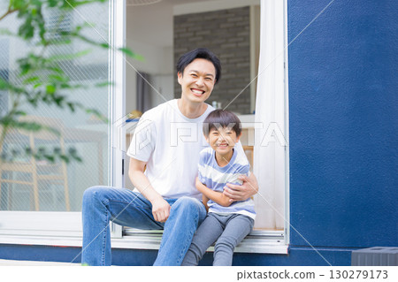 Family: Father and son relaxing in the garden Family: Father and son relaxing in the garden 130279173