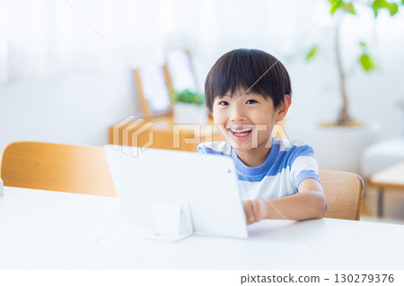 Boy studying on a tablet Boy studying on a tablet 130279376