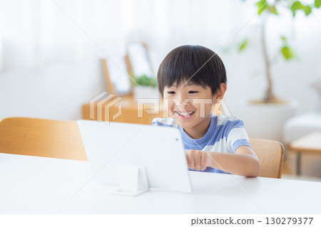 Boy studying on a tablet 130279377