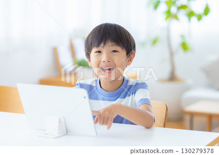 Boy studying on a tablet 130279378