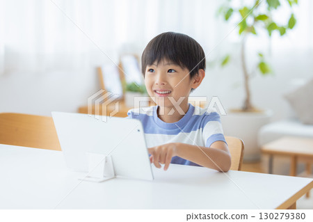 Boy studying on a tablet 130279380