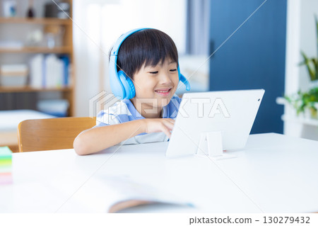 Boy studying on a tablet Boy studying on a tablet 130279432