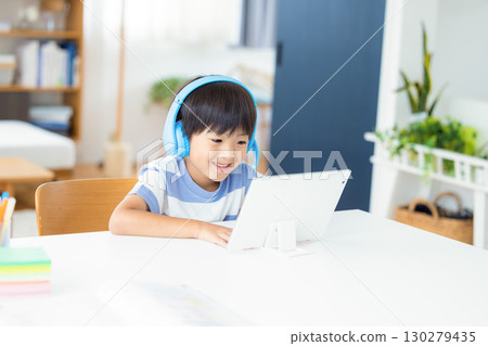 Boy studying on a tablet 130279435
