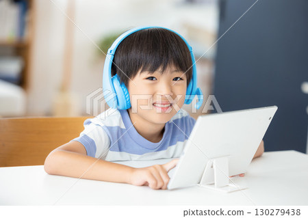 Boy studying on a tablet Boy studying on a tablet 130279438