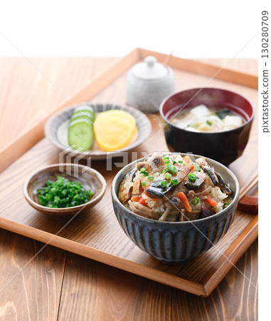 A steaming Japanese breakfast, lunch, and dinner set meal featuring a luxurious dish of mackerel jerky. 130280709