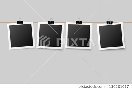 Photographs hanging on a string attached with office clips, cozy decorative concept perfect for personal memory boards, wall displays, or creative layouts. 130281017