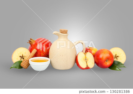 Fresh apples are arranged with honey and a decorative jug 130281386
