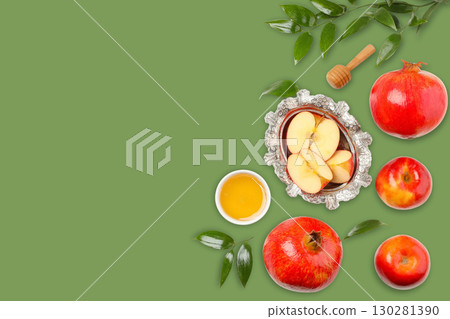 Fresh apples and pomegranates are artfully arranged beside honey Fresh apples and pomegranates are artfully arranged beside honey 130281390