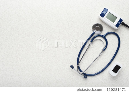 Healthcare medical background of stethoscope blood pressure monitor and pulse oximeter flat lay on table with copy-space Healthcare medical background of stethoscope blood pressure monitor and pulse oximeter flat lay on table with copy-space 130281471