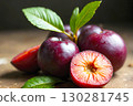 Fresh Plums with Green Leaves on Rustic Wooden Table Background 130281745